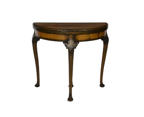 An early Georgian style fold over mahogany card table 1930's, with inset green baize over a plain frieze, raised on foliate c