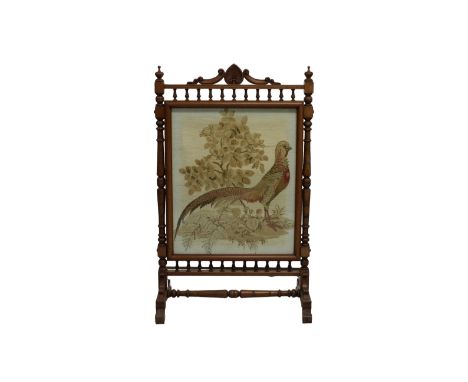 A Victorian oak fire screen with turned column supports and spindle rails above and below a central tapestry panel depicting 