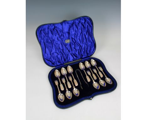 A cased set of twelve silver fiddle pattern bright cut teaspoons and tongs Joseph Rodgers &amp; Sons, Sheffield, 1916, each p