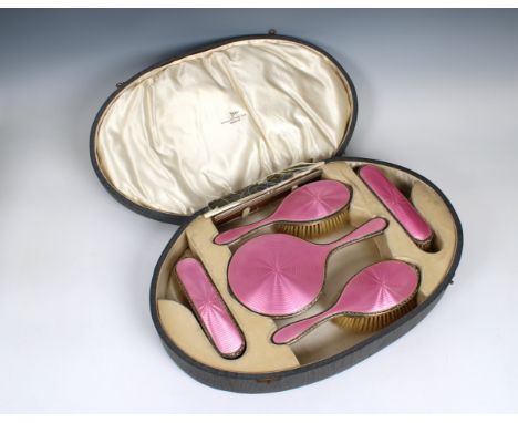 A George V cased silver and pink guilloche enamel dressing table set Walker &amp; Hall, Birmingham. 1925/26, comprising a han