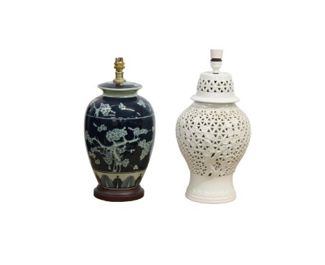 A 20th century Portuguese, Casa Pupa, white pierced ceramic lamp base with floral decoration with an unused cream pleated lam