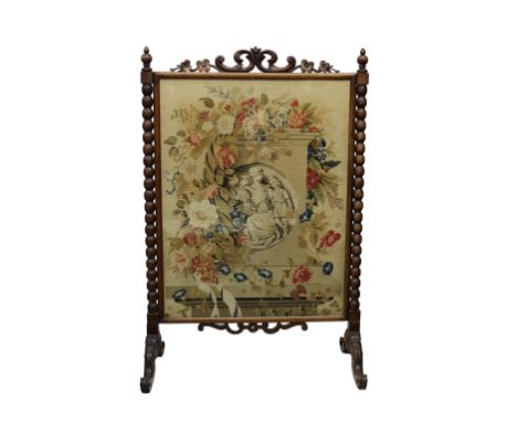 A William IV rosewood tapestry fire screen the pierced foliate crest over bobbin turned columns, on swept scroll carved feet,