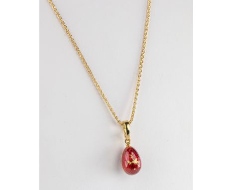 A Faberge Egg Pendant The 18ct yellow gold modern Faberge egg pendant, the egg in deep red guilloche enamel with a gold leaf 