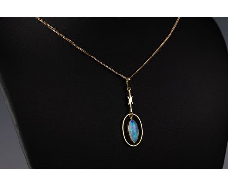 A 15ct yellow gold opal pendant The marquise shaped water opal suspended from a 15ct yellow gold pendant to a curb link chain