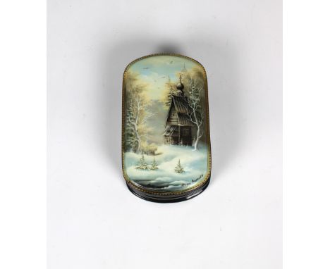 A mid to late 20th century Russian lacquered box of oval form, the hinged cover depicting a wooden shack in snowy scene, irid