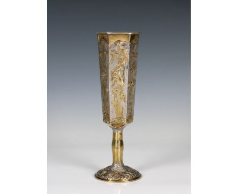 A Russian silver gilt goblet of elongated hexagonal form, having raised floral and foliate decoration, marked with 84, A.M ov