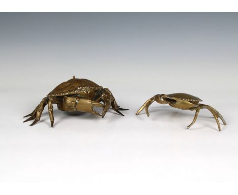 A novelty brass shop counter bell fashioned as a crab push button to shell, red glass eyes, stamped to underside 'made in Ger