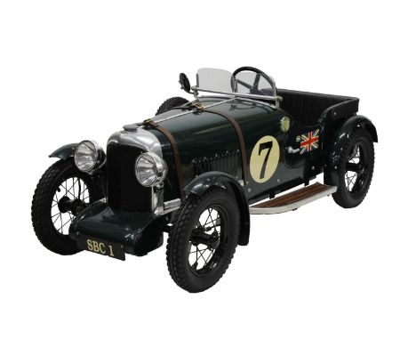 A Bentley 1930’s Le Mans style pedal car Green coachwork, number (7), Bentley badge, rubber tyres, leather strapping, electri