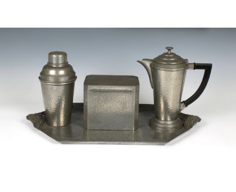 An Art Deco planished pewter matched cocktail set comprising a tray, stamped 'Craftsman', 17 7/8in. (45.5cm.) wide; cocktail 