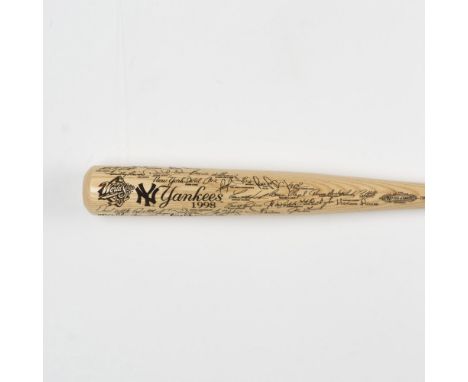 A finely crafted natural wood bat showcasing black-engraved signatures of the 1998 World Series champion New York Yankees. Ma