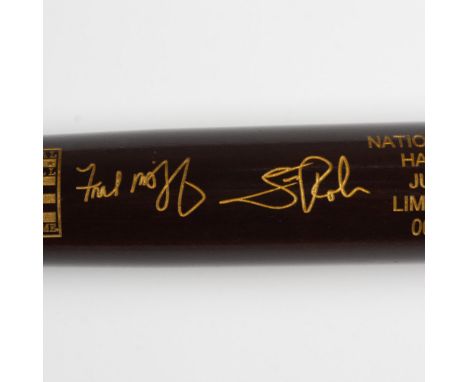 A rich mahogany-colored bat with gold-colored engravings, featuring the signatures of Fred McGriff and Scott Rolen, celebrati