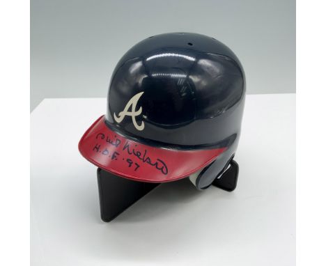 A blue and red baseball helmet with a white letter A logo for the Atlanta Braves, autographed by Phil Niekro. Phil Niekro sig