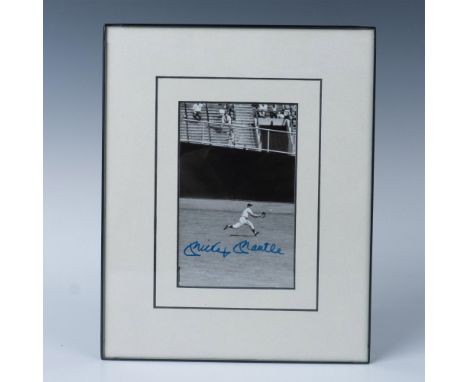 This is a black and white photo of Mantle in the outfield, also signed by him in blue ink. Certificate of Authenticity from J