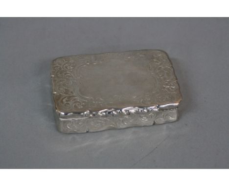 A VICTORIAN SILVER RECTANGULAR SNUFF BOX, wavy rims, foliate scroll engraved decoration, maker Edward Smith, Birmingham 1855,