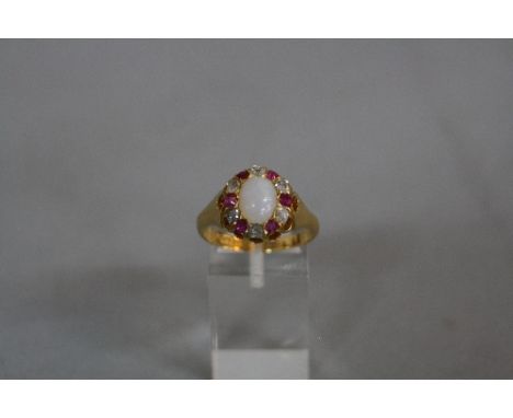 A LATE VICTORIAN OPAL, RUBY AND DIAMOND 18CT GOLD OVAL CLUSTER RING, opal measuring approximately 9 x 7mm, alternating rubies