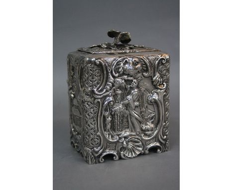 A VICTORIAN IRISH SILVER TEA CADDY, in the Rococo style, the sliding cover with floral knop, repousse and chased to the front