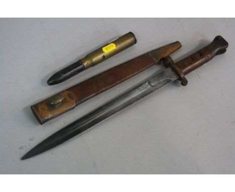 AN INERT 1943 DATED 20MM SHELL AND A WILKINSON WWII ERA RIFLE BAYONET AND SCABBARD, the leather scabbard has the inscription 