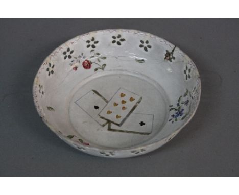 A GEORGE III CIRCULAR ENAMEL DISH, plain exterior, flower head pierced border, the interior painted with floral sprigs and th