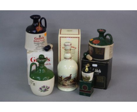 A SELECTION OF FOUR SCOTCH WHISKIES IN CERAMIC DECANTERS, 1 x The Famous Grouse in a Highland Decanter (boxed), 1 Grant's Del