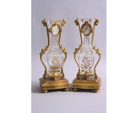 A PAIR OF MID 19TH CENTURY FRENCH ORMOLU AND ROCK CRYSTAL VASES, the vases of square baluster outline with raised gilt decora