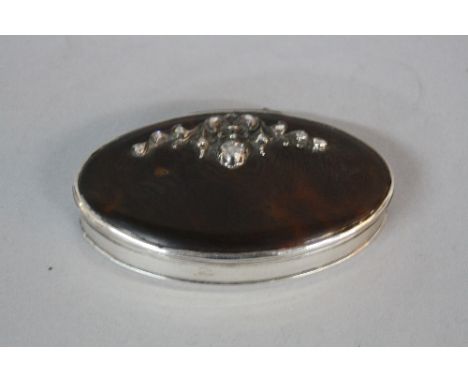 A LATE GEORGIAN OVAL WHITE METAL AND TORTOISESHELL SNUFF BOX, the cover set with rose cut diamonds in a foliate scroll mount,