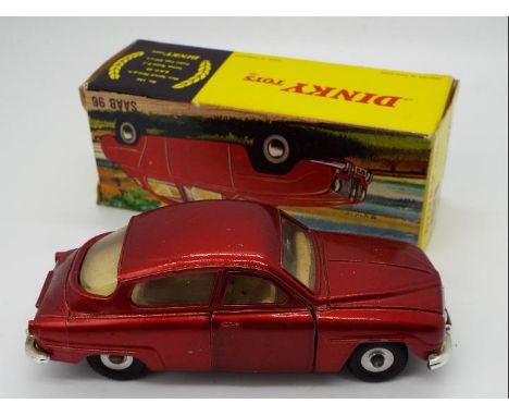 Dinky Toys - A boxed Dinky Toys #156 Saab 96. The model is in metallic red, with a cream / off-white interior and has spun hu