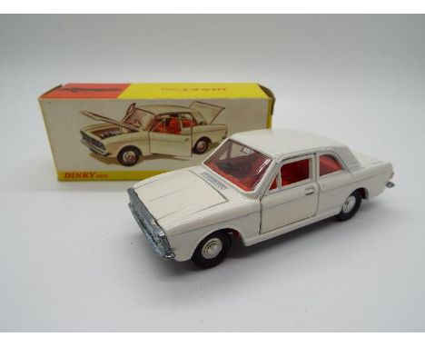 Dinky Toys - A boxed Dinky Toys #159 Ford Cortina De Luxe. Finished in white body, with red interior and cast hubs. The model