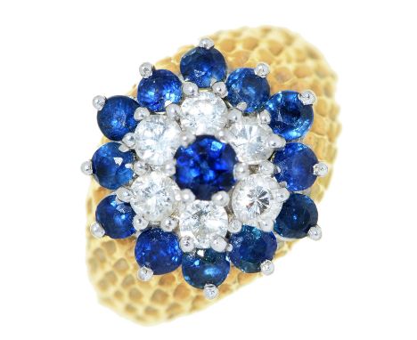 A sapphire and diamond cluster ring,&nbsp; in textured 18ct gold, Birmingham 1975, 7.8g, size K Good condition