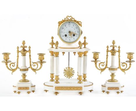 A French statuary marble and ormolu garniture de cheminee, early 20th c, in Louis XVI style, the colonnade clock with enamel 