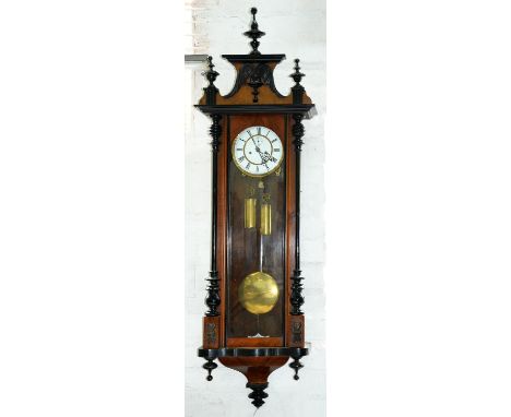 An ebonised and walnut Vienna wall clock, late 19th c, architectural pediment with spire finials, the white enamel dial with 