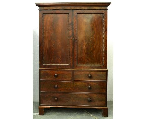 A Victorian mahogany linen press, applied with bead mouldings and enclosed by a pair of doors, the doors with plain figured p