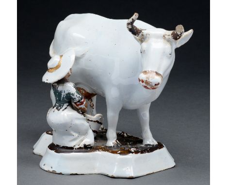 A Dutch Delftware figure of a milkmaid, early 19th c, 19cm h Enamel flaking, damage to extremities particularly cow's horns