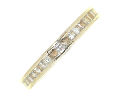 A diamond eternity ring,  with princess cut diamonds, white gold mount marked 18k, 2.8g, size I Encrusted with dirt and light