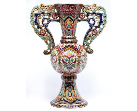 A Zsolnay vase, late 19th c, of Persian inspiration, decorated with shaped panels of stylised flowers between flared neck and