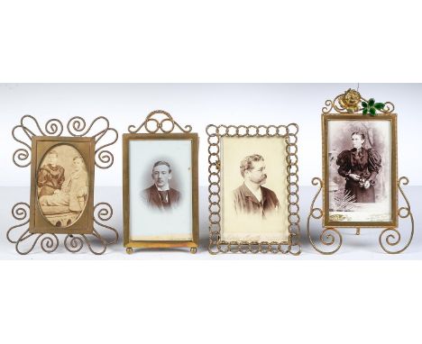 Four German brass and wirework photograph frames, c1910, one of chain pattern, another with rose and green enamel leaf cresti