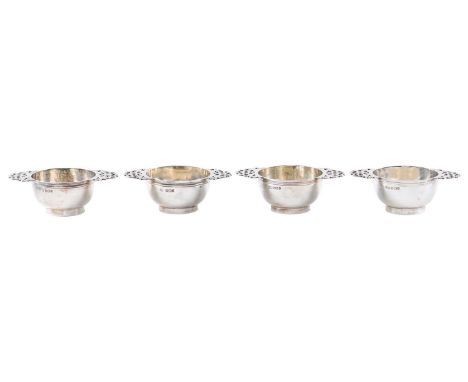 A set of four silver porringer form salt cellars, with pierced handles, on ring foot, 84mm over handles, by Harrison Brothers