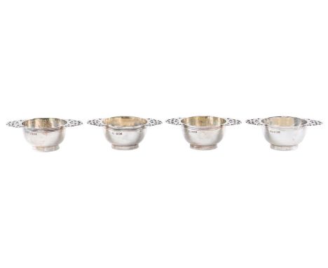 A set of four silver porringer form salt cellars, with pierced handles, on ring foot, 84mm over handles, by Harrison Brothers