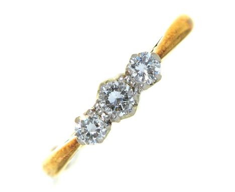 A three stone diamond ring, in gold marked 18ct PLAT, 2.2g, size K  Good condition