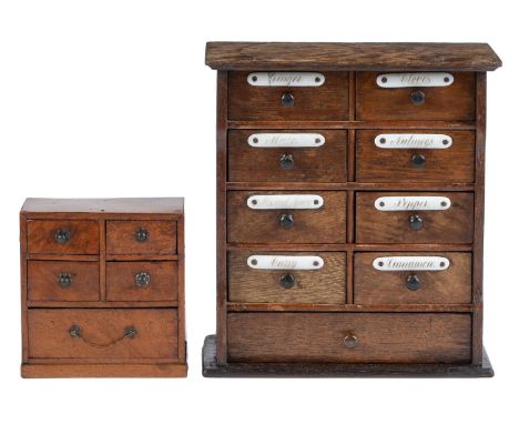 A set of oak spice drawers, late 19th c, the oversailing top above eight short and one long drawer, the eight small drawers e