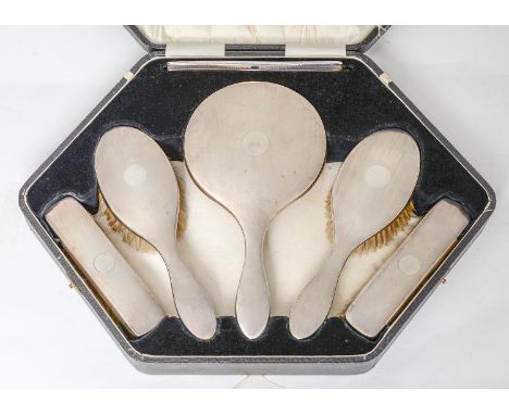 A George V six piece silver brush set, engine turned, mirror 27cm l, by Hasset &amp; Harper Ltd, Birmingham 1928, cased  One 