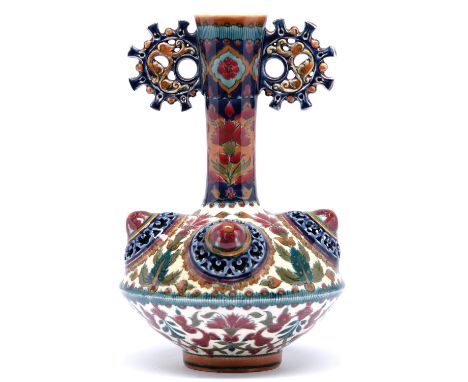 A Zsolnay vase, late 19th c, the flared neck with round handles above four reticulated bosses, decorated with flowers in coba