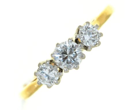 A three stone diamond ring, with round brilliant cut diamond, in gold marked 18ct, 2.3g, size N  Light wear consistent with a