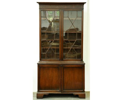 A mahogany bookcase, early 20th c,&nbsp; the upper part with cavetto cornice and blind fret carved frieze, fitted with adjust