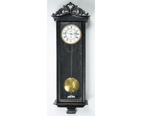 An ebonised Vienna wall timepiece, late 19th c, the enamel dial with subsidiary seconds ring and pierced hands, in arched cas