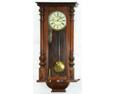 A walnut&nbsp; Vienna wall clock, late 19th c, the cavetto flared cornice above arched glazed door, flanked by fluted split p