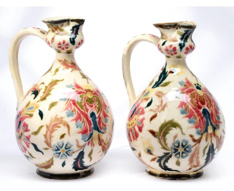 A pair of Zsolnay ewers, late 19th c, decorated with flowers and scrolling foliage, 20cm h, impressed and printed marks  Good
