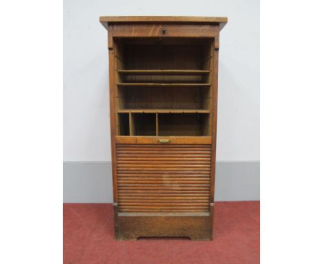 An Early XX Century Oak Filing Cabinet, with tambour front, fitted interior (some shelving and dividers missing), on small br