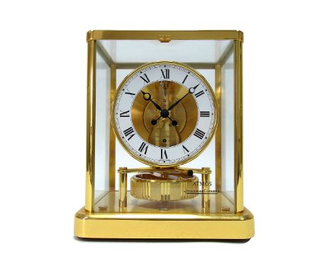 A Jaeger Le Coultre Atmos Mantle Clock, the white enamel chapter ring with black Roman numerals, the rectangular brass case w