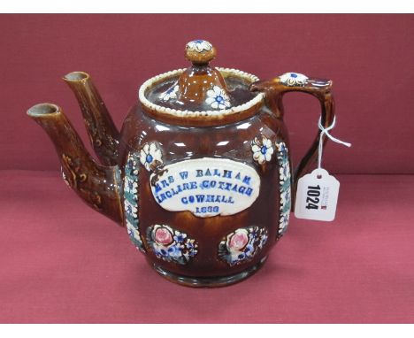 A Mid XIX Century Barge Ware Pottery Double Spouted Teapot and Cover, the brown glaze applied with flowers and central plaque