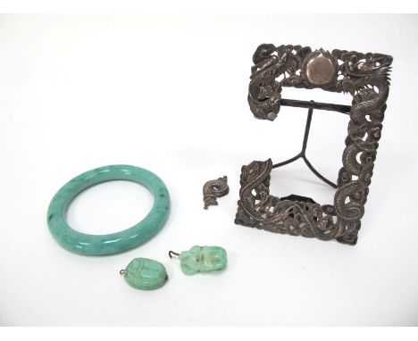 A Late XIX Century Chinese White Metal Picture Frame, elaborately embossed with dragons, 10cm long; A Green Hardstone Bangle,